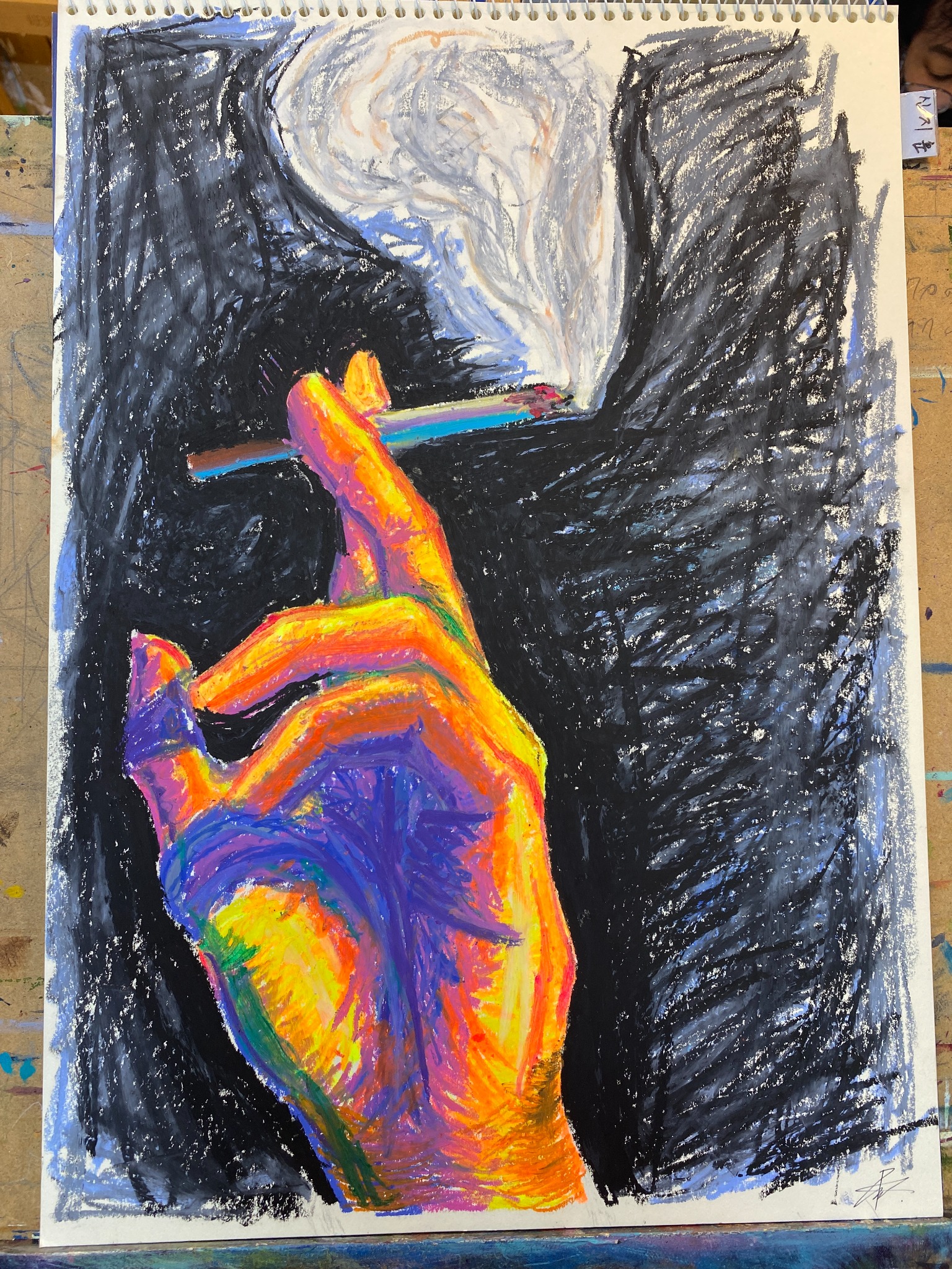 Expressive multicolored hand holding a smoking cigarette against dark crayon strokes